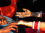 Amritsar: A woman gets henna applied on her hands on the eve of 'Karwa Chauth' in Amritsar, Wednesday, Oct. 12, 2022. (Photo:Pawan sharma/IANS)