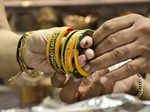 Nagpur: A woman tries bangles on her hand to buy on the eve of Karwa Chauth festival, in Nagpur on Wednesday, Oct. 12, 2022. (Photo: Chandrakant Paddhane/IANS)