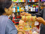 Haridwar: A woman tries bangles to buy from a shop ahead of the Karwa Chauth festival, in Haridwar on Tuesday, Oct. 11, 2022. (Photo: Rameshwar Gaur/IANS)