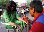 New Delhi: A married woman getting henna done on her hand on the eve of Karwa Chauth festival, in New Delhi on Wednesday, Oct. 12, 2022. (Photo: Wasim Sarvar/IANS)