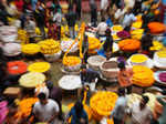 Bengaluru: People buy flowers at a wholesale market on the eve of Diwali festiva...