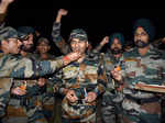 Jammu, Oct 23 (ANI): Army personnel feed sweets to each other during the Diwali ...