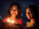 Bhopal, Oct 24 (ANI): Women light lamps on the eve of Diwali festival, in Bhopal...