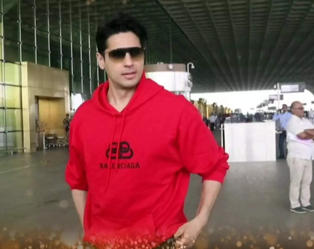 
Sidharth Malhotra opts for red hoodie paired with black pant, jets off in style
