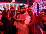 A Saudi man takes a photo with people dressed in costumes to celebrate Halloween during "Scary Weekend Event" at Boulevard, during Riyadh Season in Riyadh