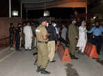 Police officers stand outside the main entrance of the hospital where former Pak...