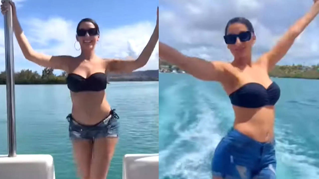 Watch: Nora Fatehi accidentally drops mobile phone in water as she enjoys  pool time in a sexy bikini
