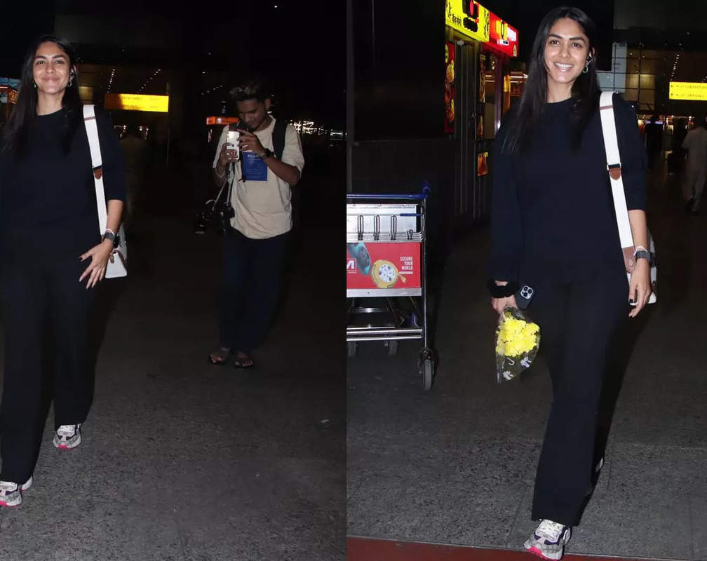 
Mrunal Thakur dons a black top paired with flair pants, choses sling bag to complete her look
