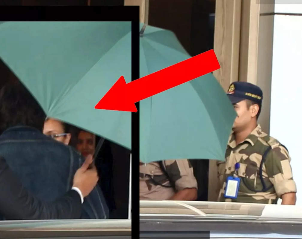 
Shah Rukh Khan does it again! Hides his face behind umbrella at Kalina airport
