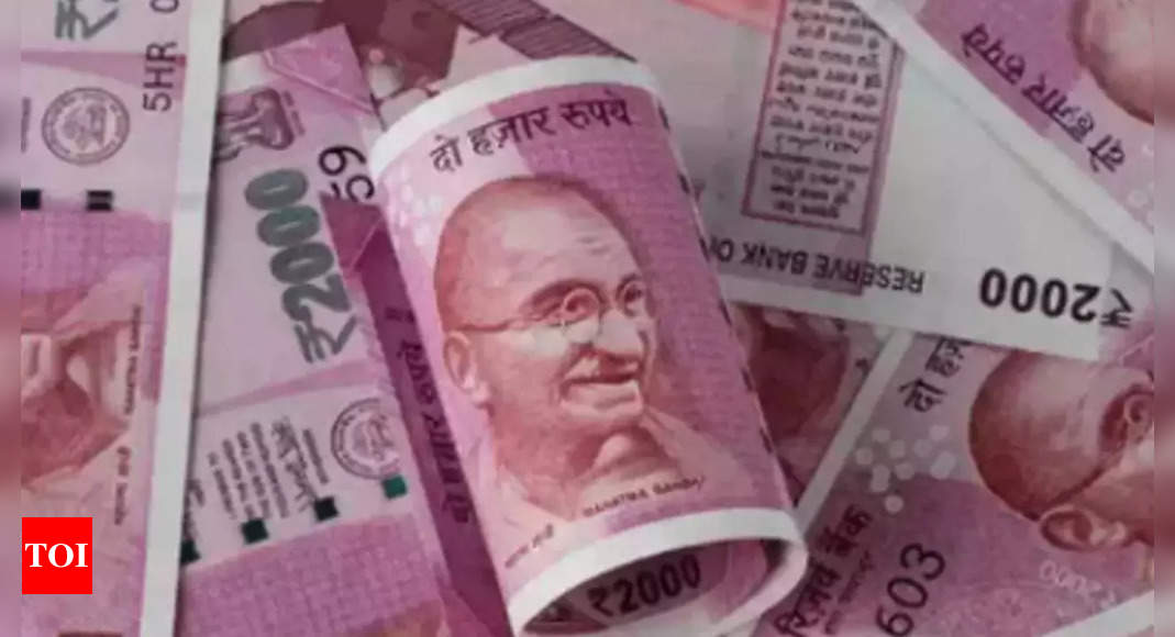 Rupee slips after positive opening on corporate dollar demand – Times of India