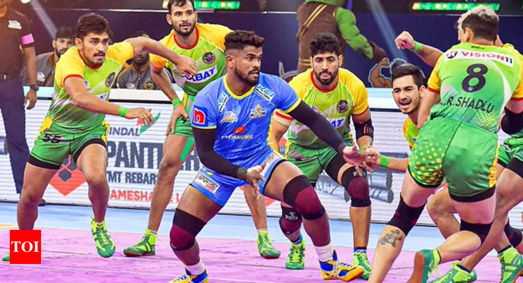 Tamil Thalaivas' K. Prapanjan, in blue and yellow jersey, is pinned down by  players of Patna Pirates during their Vivo Pro Kabaddi league match in  Mumbai, India, Saturday, Aug. 26, 2017. (AP