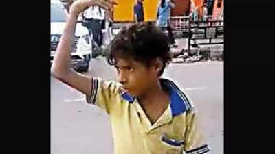 Kid 'mans' traffic in Guwahati's busy area