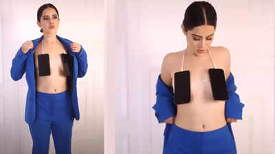 Urfi Javed shares video covering her modesty with mobile phones; troll writes, 'Laptop ka skirt bana lena tha'