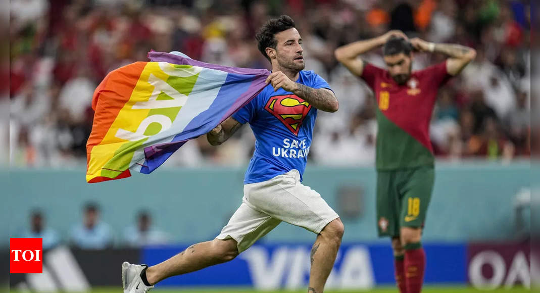 Watch: Man with rainbow flag invades pitch during FIFA World Cup match | Football News – Times of India