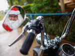 Helton Garcia dressed as Santa Claus rides on a motorcycle before distributing small presents to children in a rural school in Santo Antonio do Descoberto, state of Goias