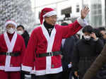 South Korean Prime Minister Han Duck-soo clad in Santa Claus costumes arrives at...