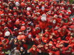 Patna: Students dressed as Santa Claus celebrate Christmas at a school, in Patna...