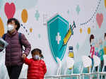 A woman holds hand of the child at a community vaccination centre, ahead of an expected border reopening with China, during the coronavirus disease (COVID-19) pandemic in Hong Kong