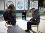 A street barber shaves the head of a customer as China returns to work despite continuing coronavirus disease (COVID-19) outbreaks in Beijing