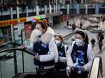 Women carry promotion material in a shopping district as China returns to work despite continuing coronavirus disease (COVID-19) outbreaks in Beijing