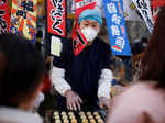 A man sells street food in a shopping district as China returns to work despite continuing coronavirus disease (COVID-19) outbreaks in Beijing