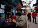 Elderly people walk past a pharmacy in Yongquan county