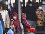 People wait to receive bodies of friends and relatives, victims of a plane crash...