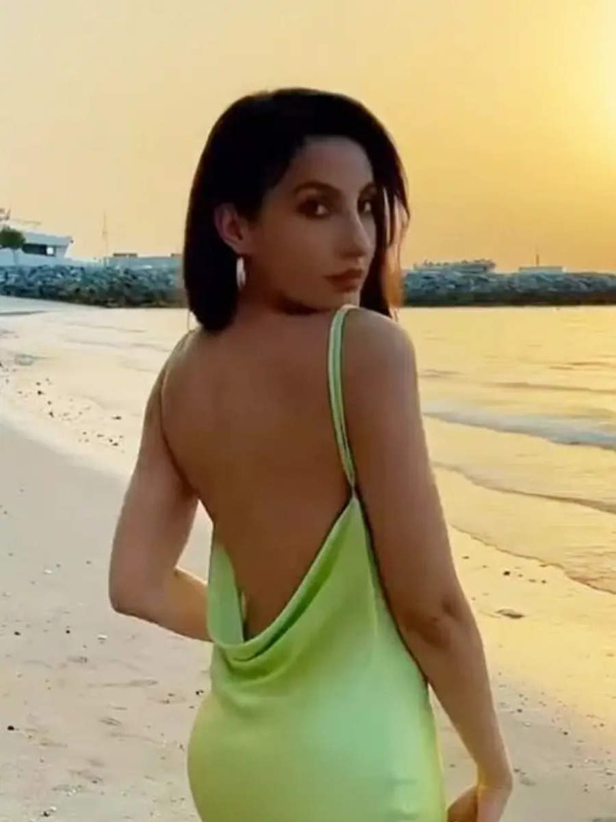 Nora Fatehi flaunts her glam in a lime backless dress by the beach
