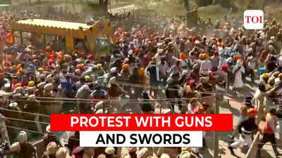 Supporters of 'Waris Punjab De' chief Amritpal Singh break through police barricades brandishing guns in Amritsar