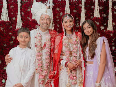 Newlyweds Dalljiet and Nikhil pose with their kids