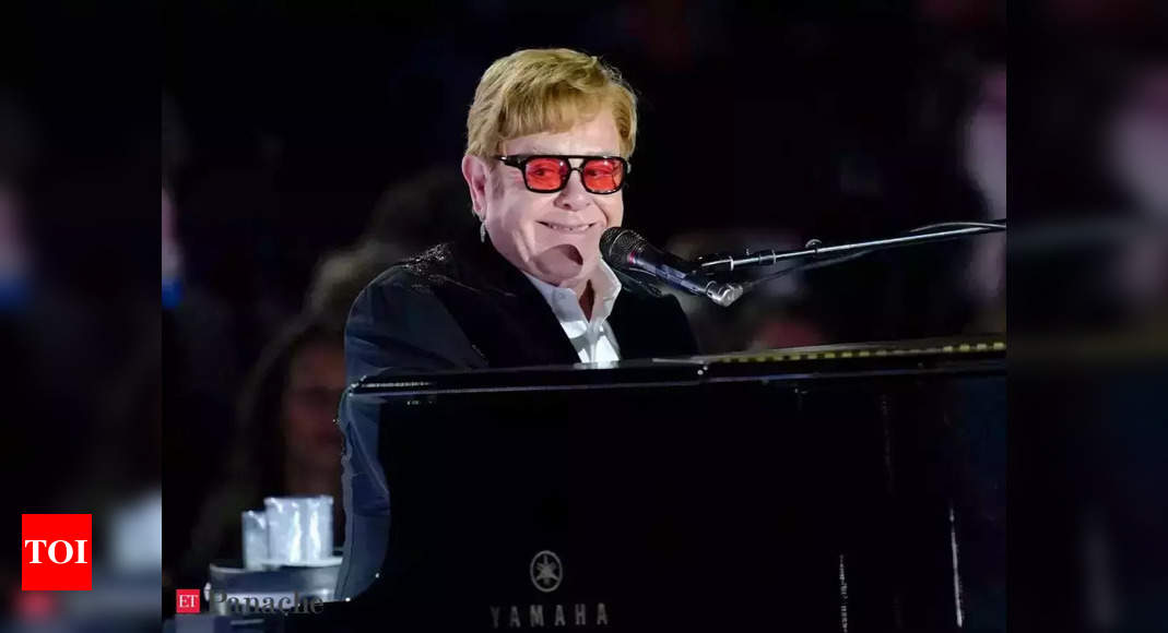 Elton John gets into shape for his farewell Yellow Brick Road tour by walking around in his swimming pool – Times of India