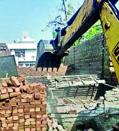 MC’s bulldozer runs over 3 illegal bldgs