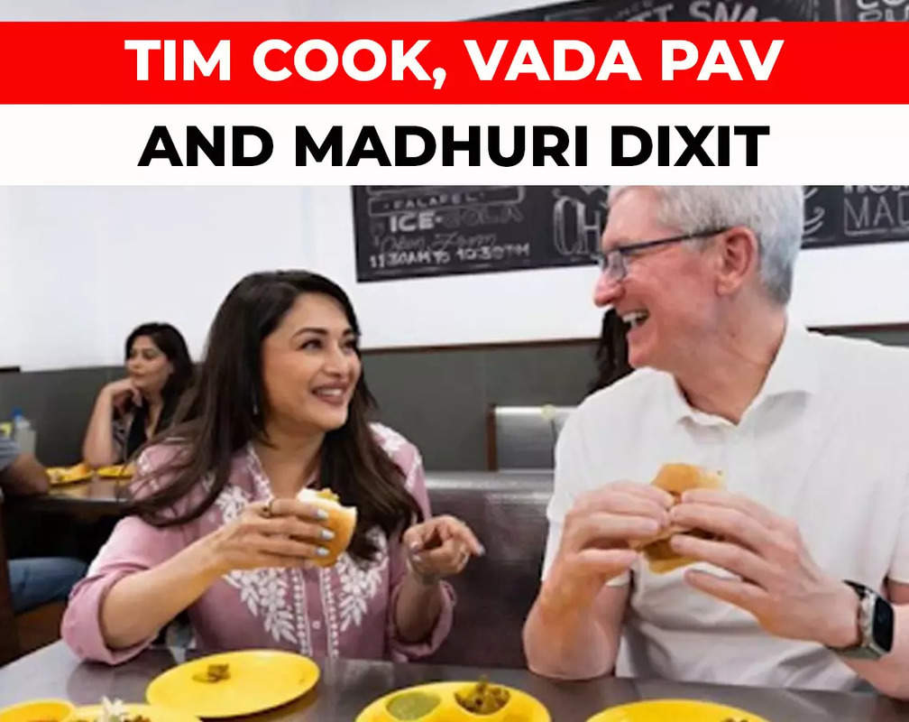 
Apple Store launch in Mumbai: CEO Tim Cook eats 'Vada pav' with Madhuri Dixit
