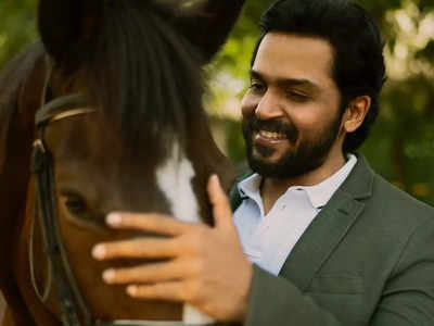 Karthi makes a grand entry in a car accompanying horses to watch 'Ponniyin Selvan 2' FDFS with fans