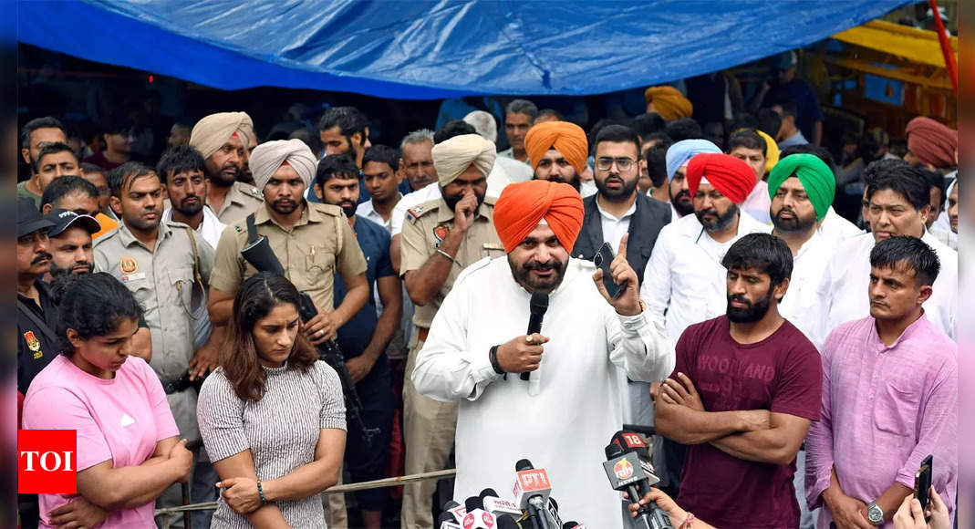Rain causes chaos but wrestlers not to leave protest site; Sidhu demands custodial interrogation of Brij Bhushan | More sports News – Times of India