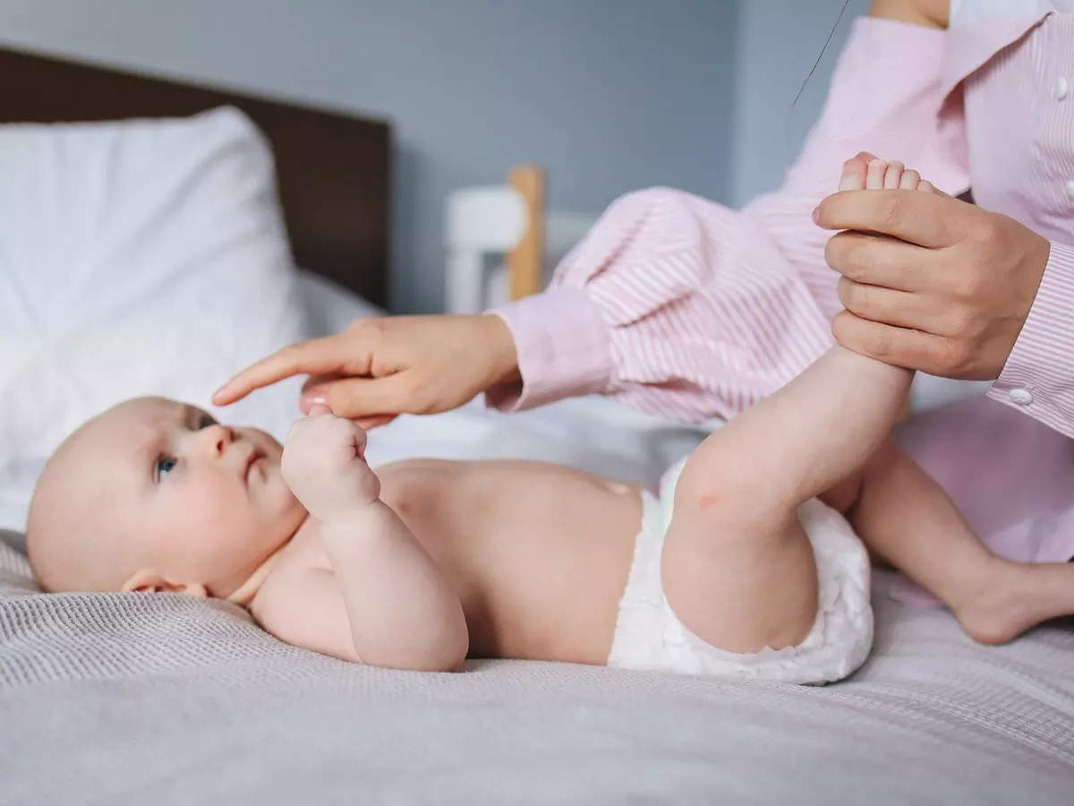 Mother Checking Pull Up Diaper Pants on Toddler Stock Photo