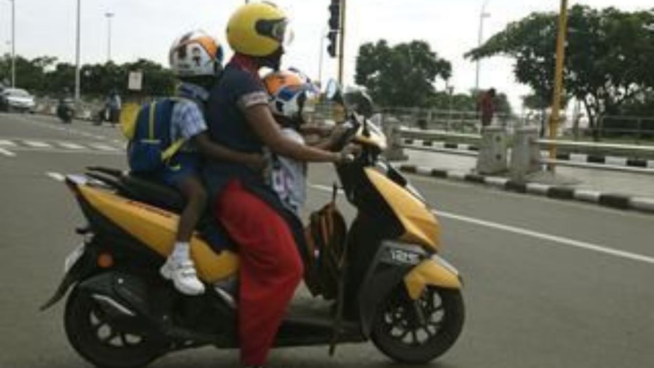 Helmet, safety harness to be mandatory for kids riding pillion from February next year - The Times of India