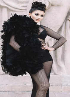 Urvashi Rautela commands attention at PFW in black net dress with dramatic feather sleeve