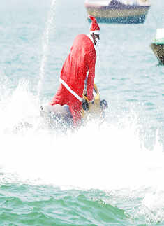 Santa Claus enjoys a jet-ski ride