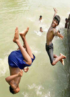 Children jump into the Ganga river to beat the heat Photogallery - Times of India