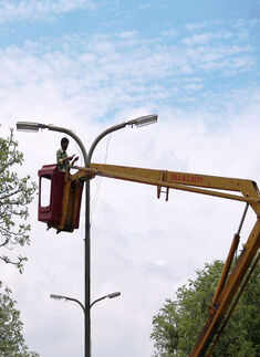 AMC worker repairs city's streets lights