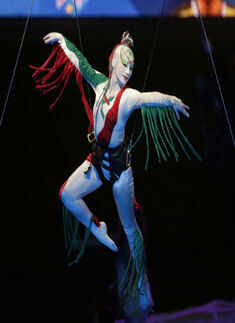 A performer dangles from a balloon