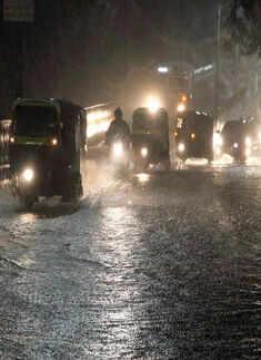 Vehicles wade through a water logged road