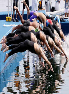 Competitors dive in the water