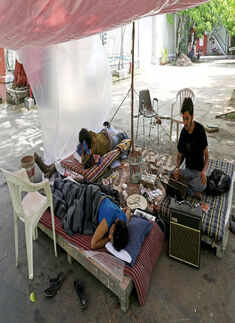 Striking students rest under an