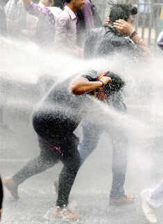 AAP workers being water-cannoned while crossing the barricades