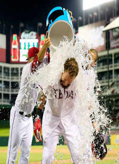 Texas Rangers designated hitter Josh Hamilton (32) gets a gatorade bath from starting pitcher Martin Perez