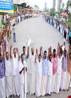 CPM leaders staging a human chain demanding