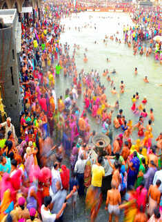 Hindu devotees perform a holy dip