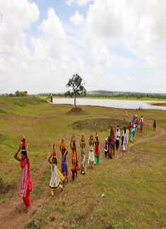 Devotees take water from Kalamba Lake